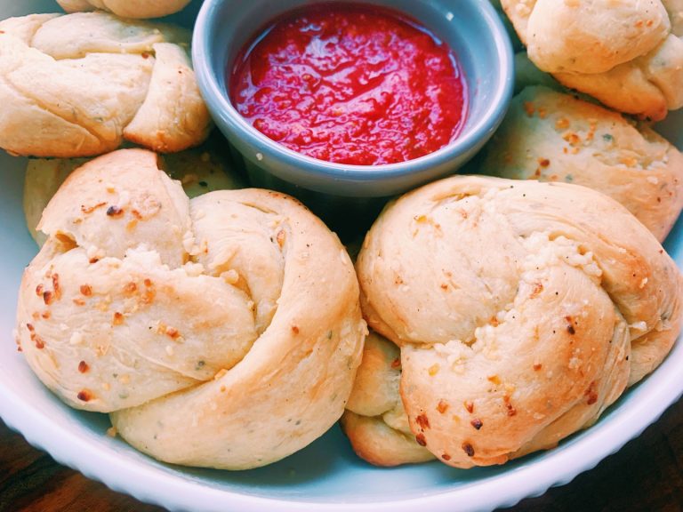 garlic knots on a plate with marinara sauce