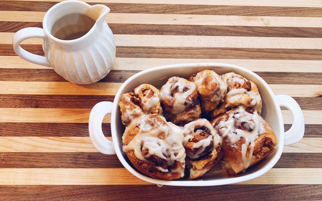 Cinnamon pecan rolls with icing in a pan 