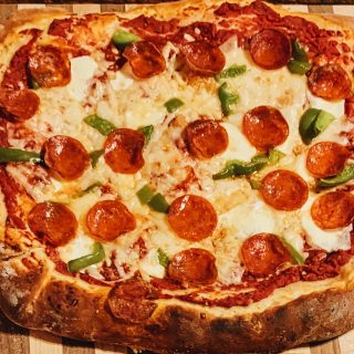 sourdough pepperoni pizza on a cutting board