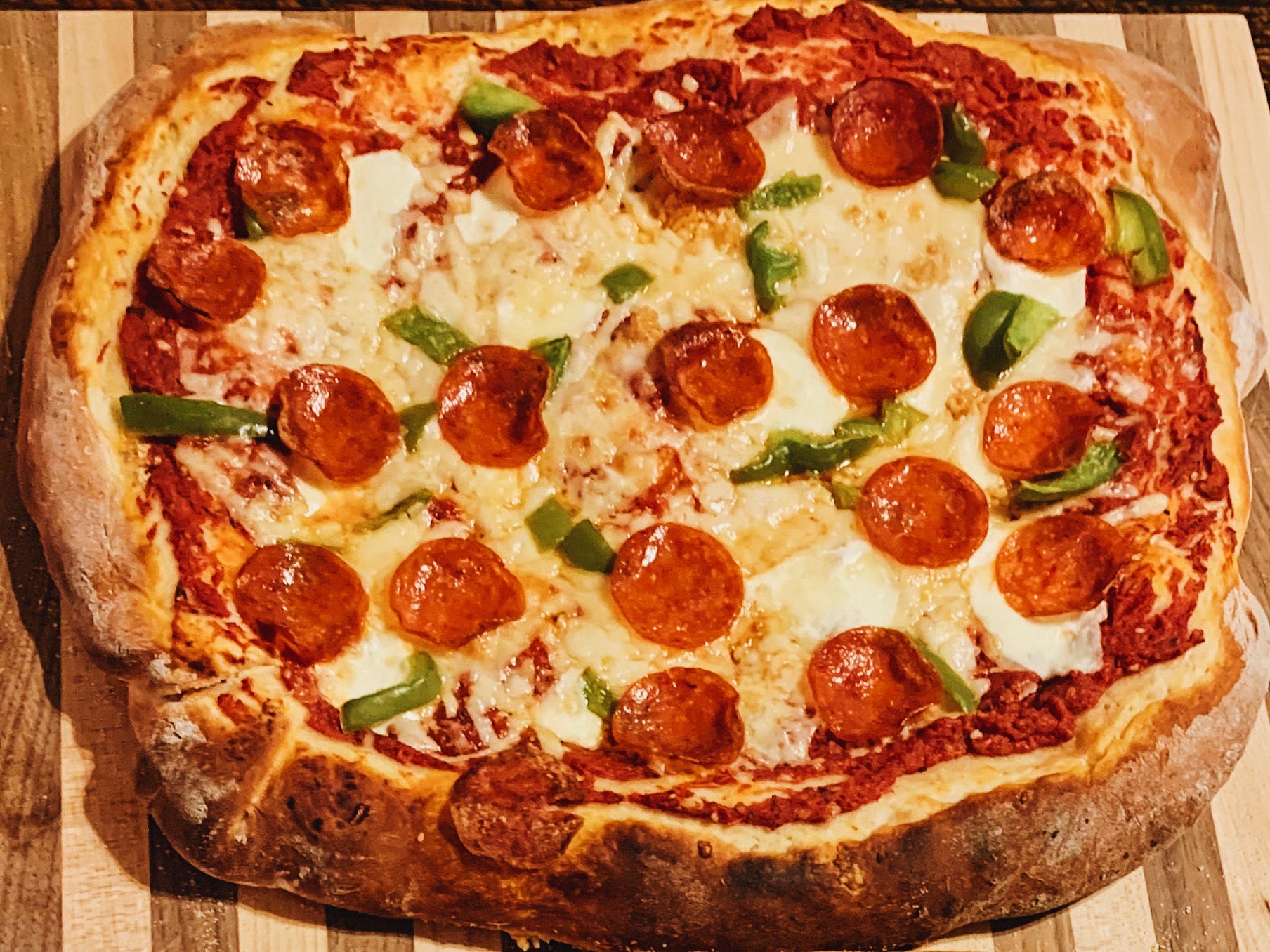 sourdough pepperoni pizza on a cutting board