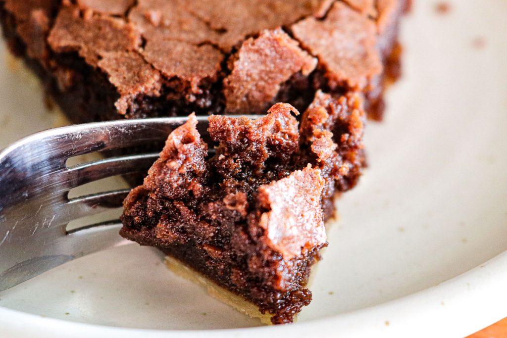 upclose fork in a slice of chocolate fudge pie