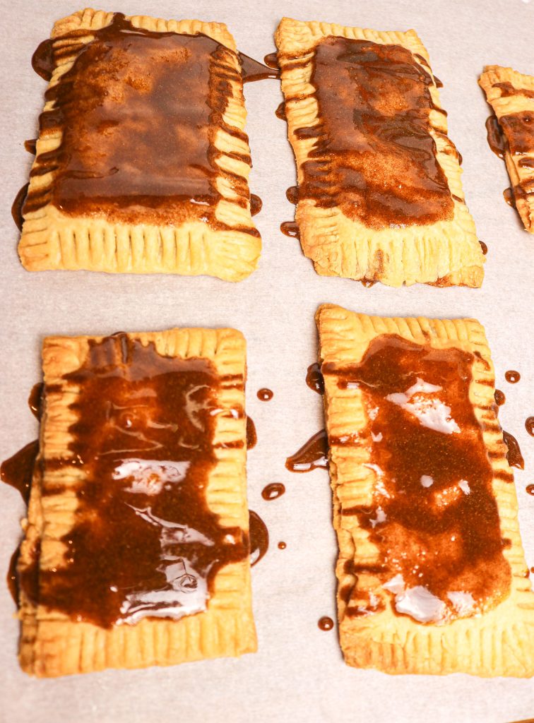 brown sugar on pop tarts on parchment paper