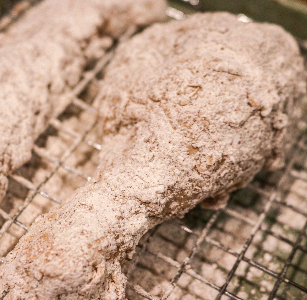 raw chicken drumstick dredged in flour