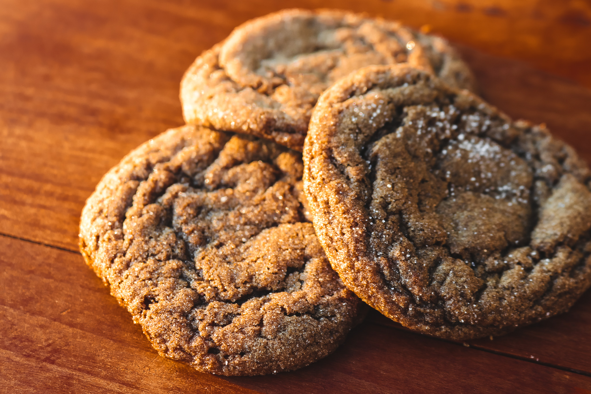 3 ginger cookies on a wooden counter top