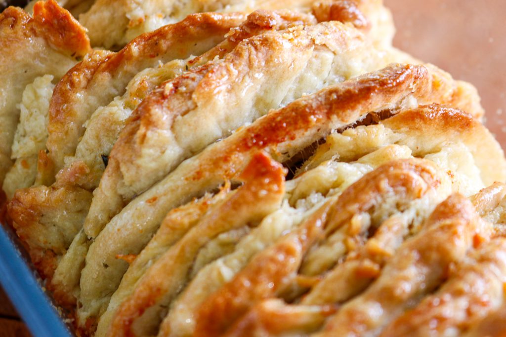 the top of a pull apart bread load brushed with butter 