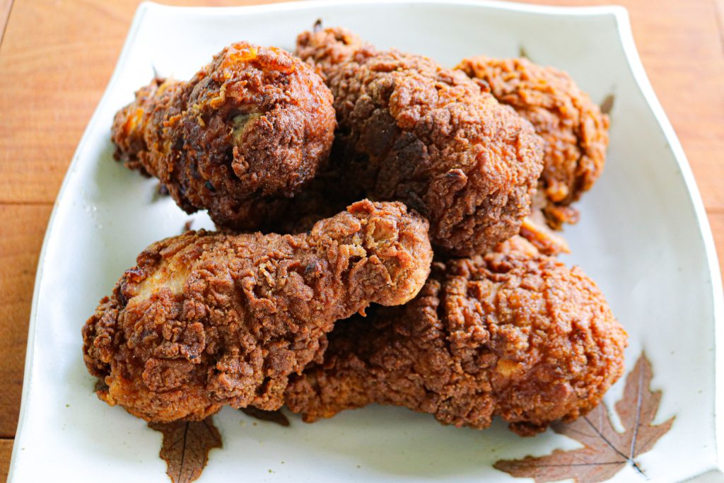 a plate of fried chicken drumsticks