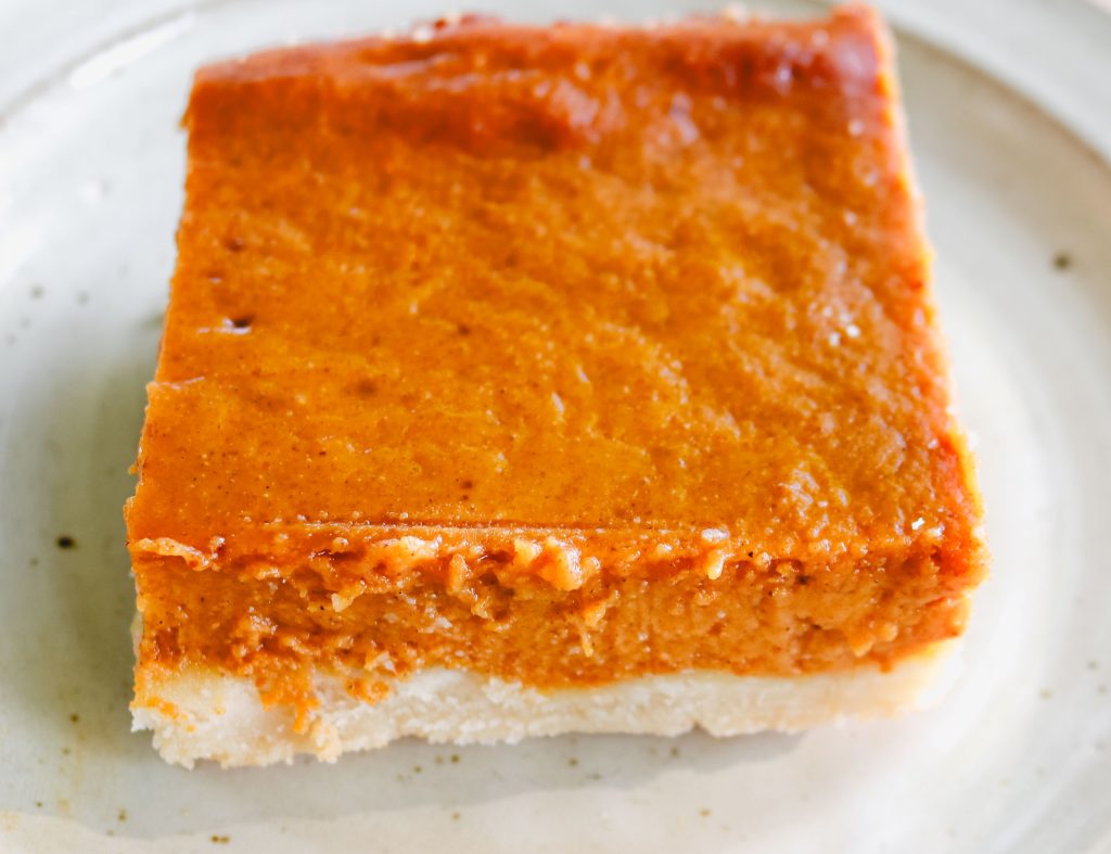 slice of pumpkin pie bars on a white plate