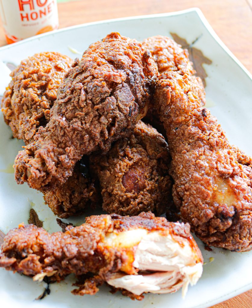 fried chicken on a plate with mikes hot honey bottle in the background