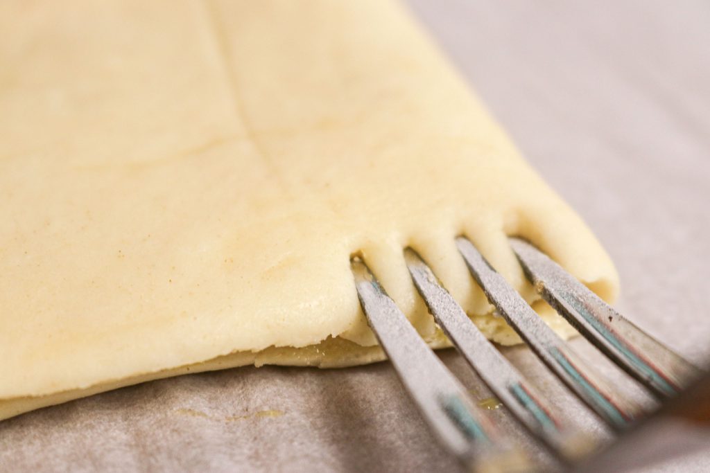 fork crimping the edge of poptart dough