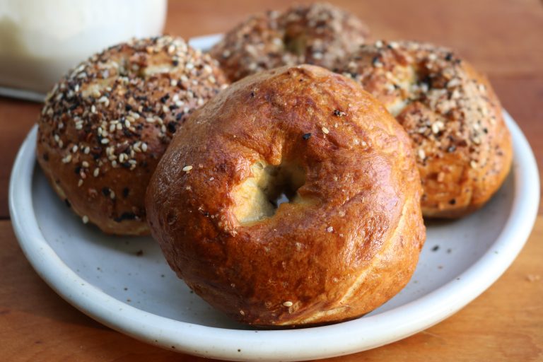 a white plate of bagels