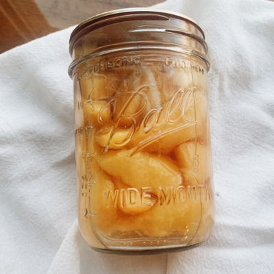 jar of peaches on a white towel