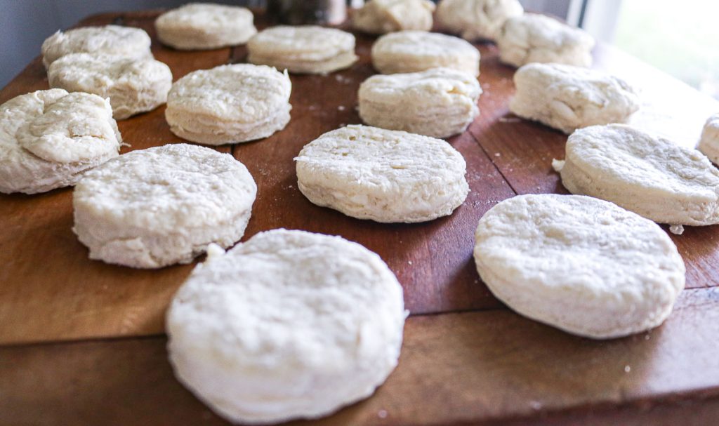 unbaked biscuits on a wooden counter