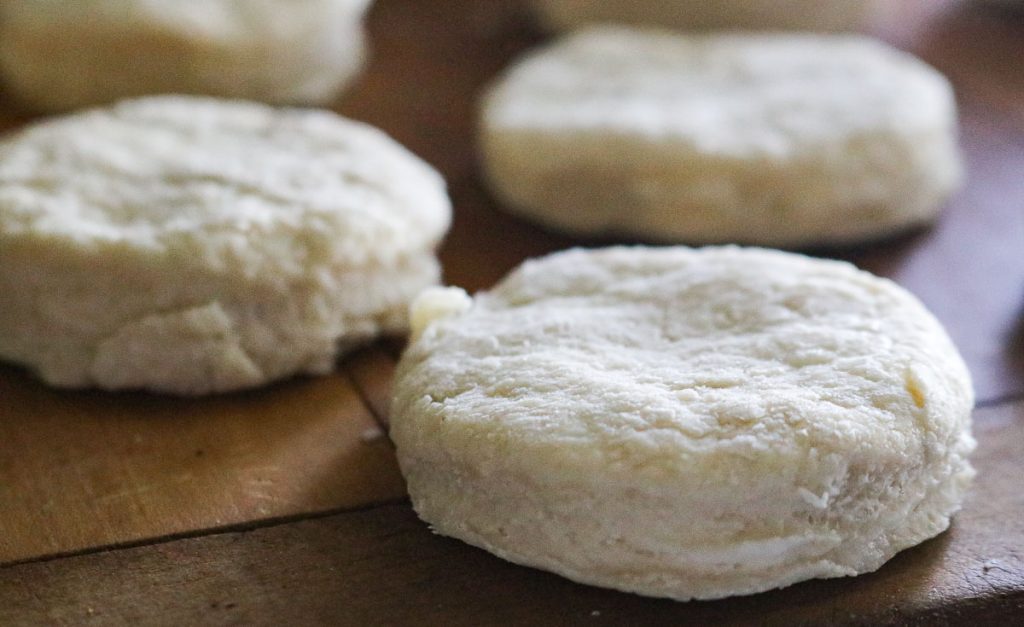 unbaked biscuits on a wooden counter
