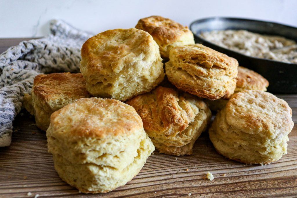 Flaky sourdough biscuits served with homemade sausage gravy in a skillet
