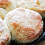 side shot of biscuits in a cast iron pan