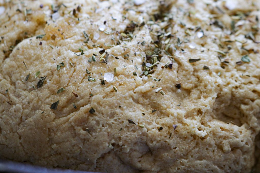 sea salt and herbs on dough