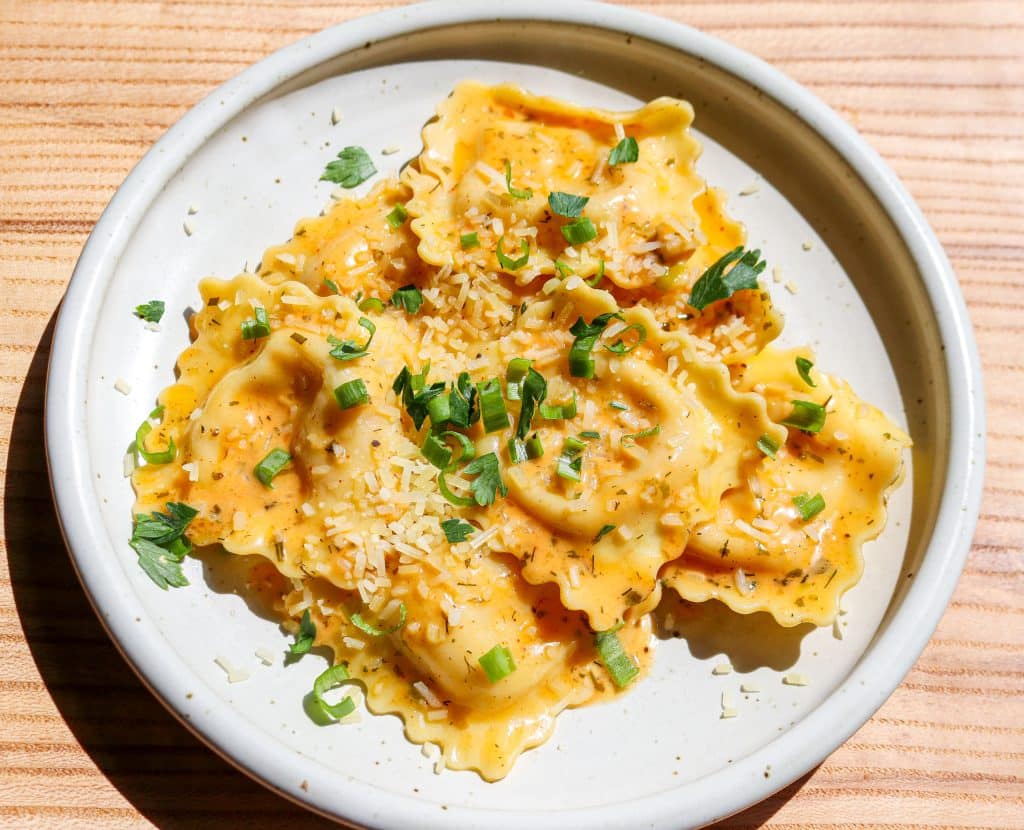 plate of lobster ravioli with butter sauce