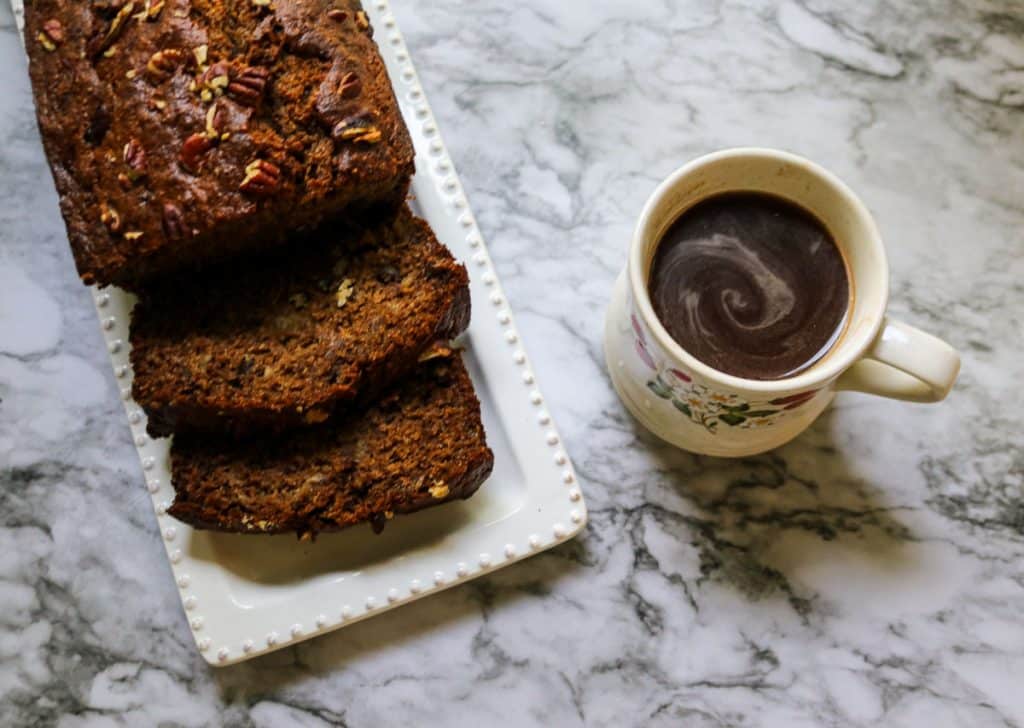 sliced banana bread with coffee on a marble counter