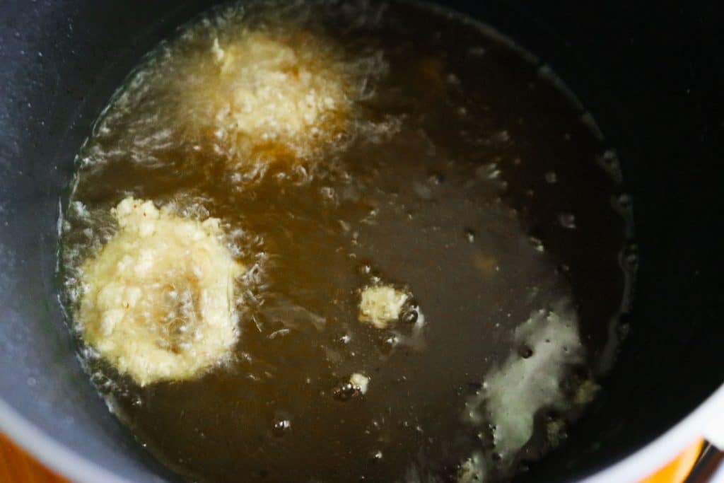 sourdough rings frying in a deep fryer
