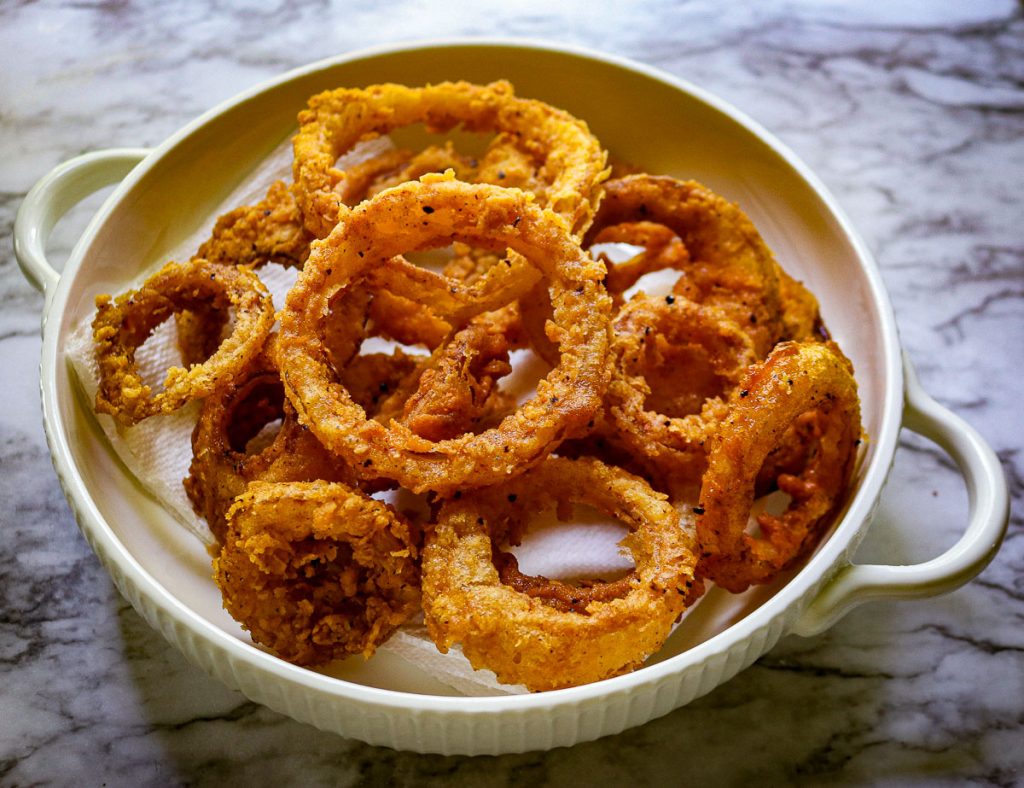 sourdough onion rings on a white plate