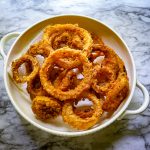 sourdough onion rings on a white plate