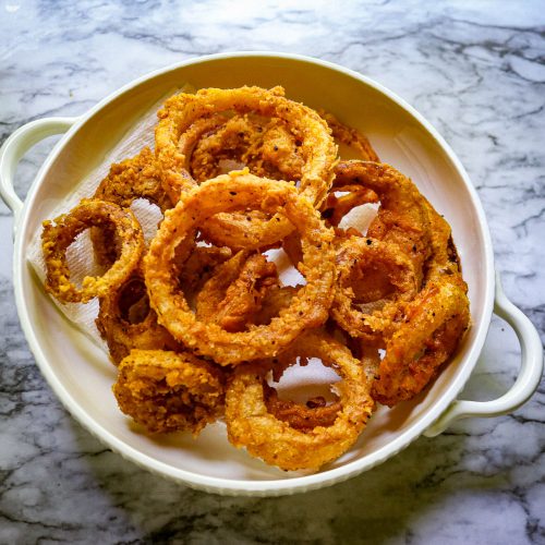 sourdough onion rings on a white plate