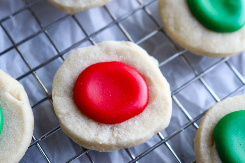 red thumbprint cookie on a wire rack