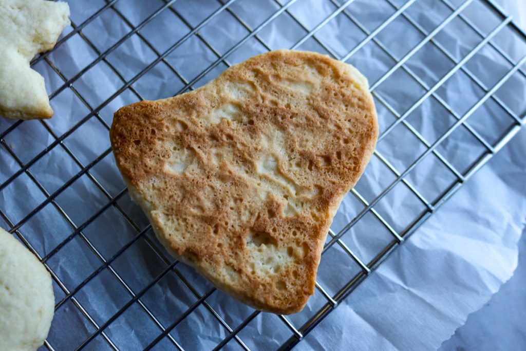 backside of a baked sugar cookie on a wire rack