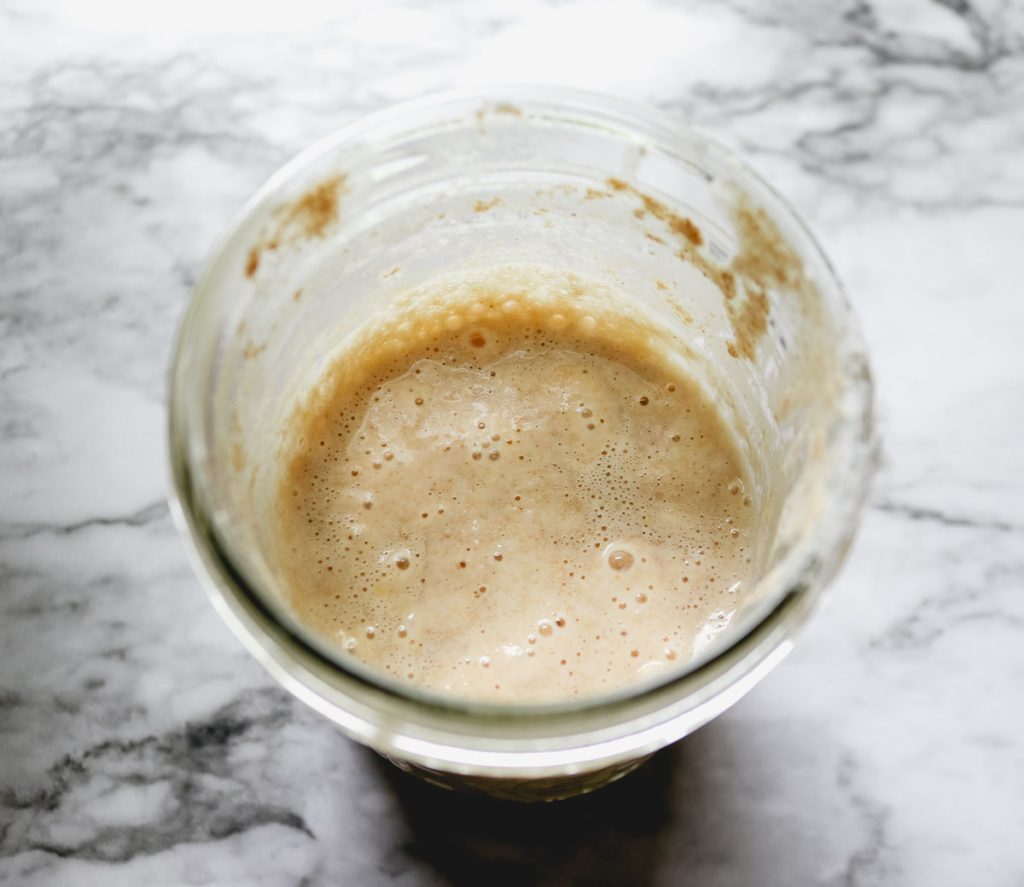 Unfed sourdough starter resting in a glass jar