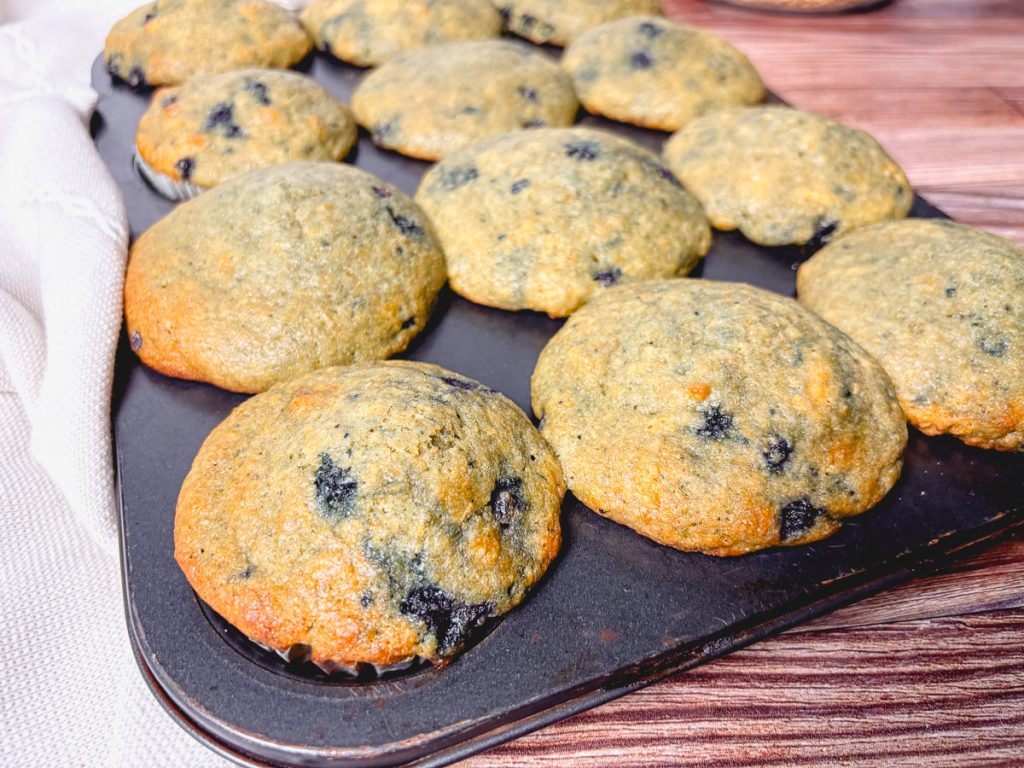 side shot of a full tray of blueberry muffins made with whole grains