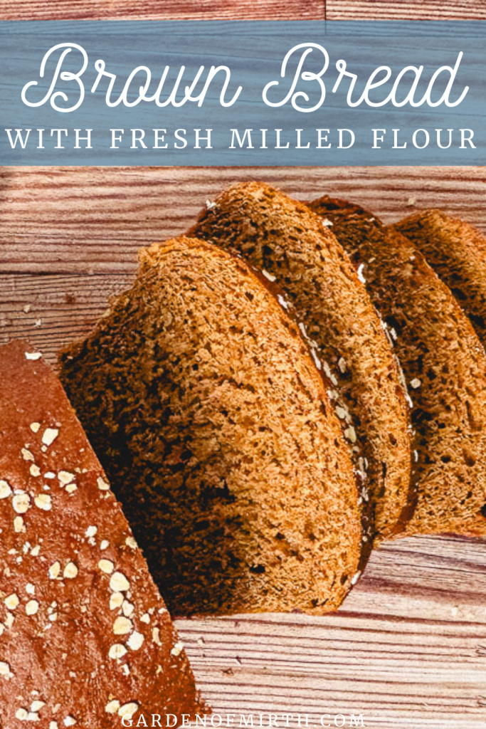 a pinterest pin for brown bread with fresh milled flour, with an image of sliced bread