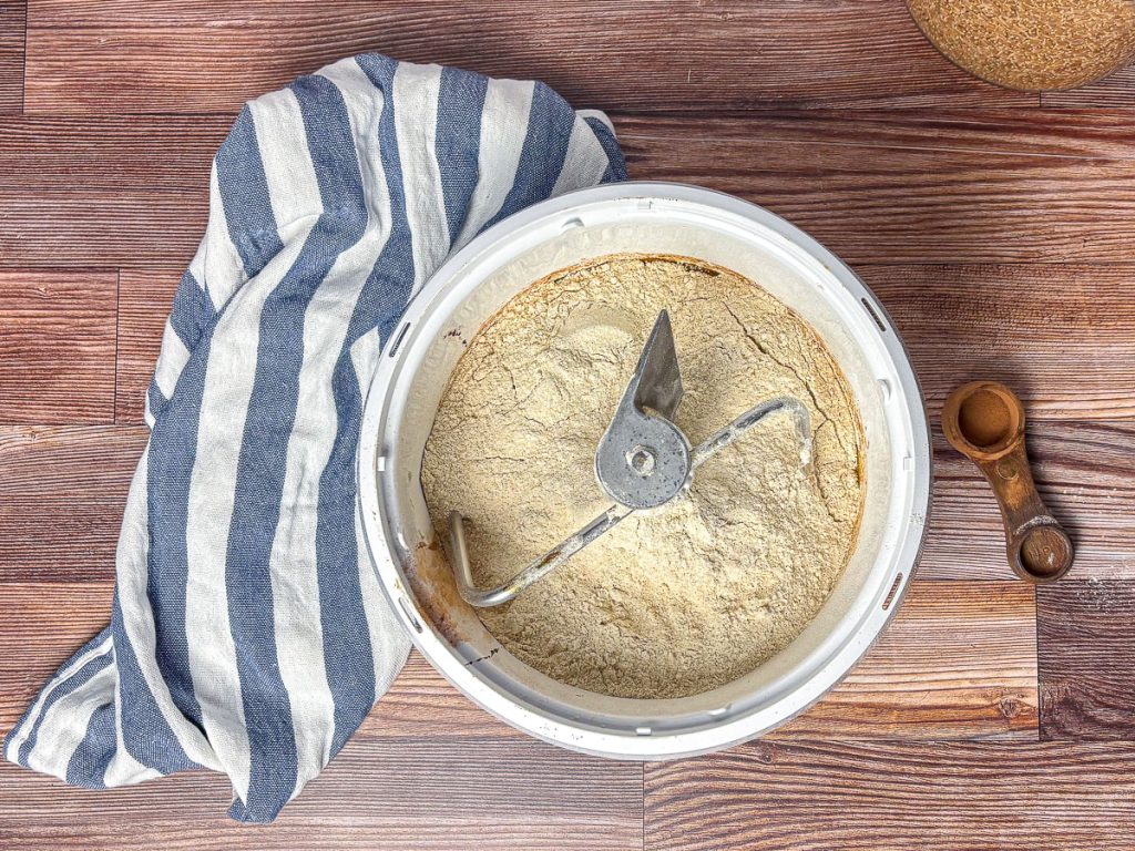 Fresh-milled flour and ingredients for honey wheat bread in a Bosch mixer before kneading.