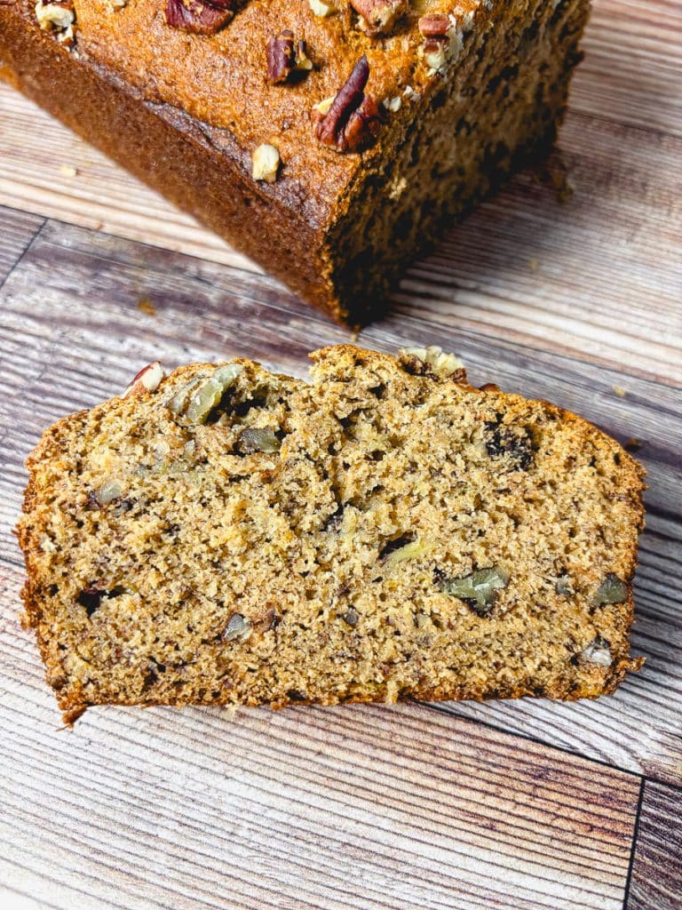 Fresh-milled flour banana bread with a slice cut to show its moist, nutty interior.