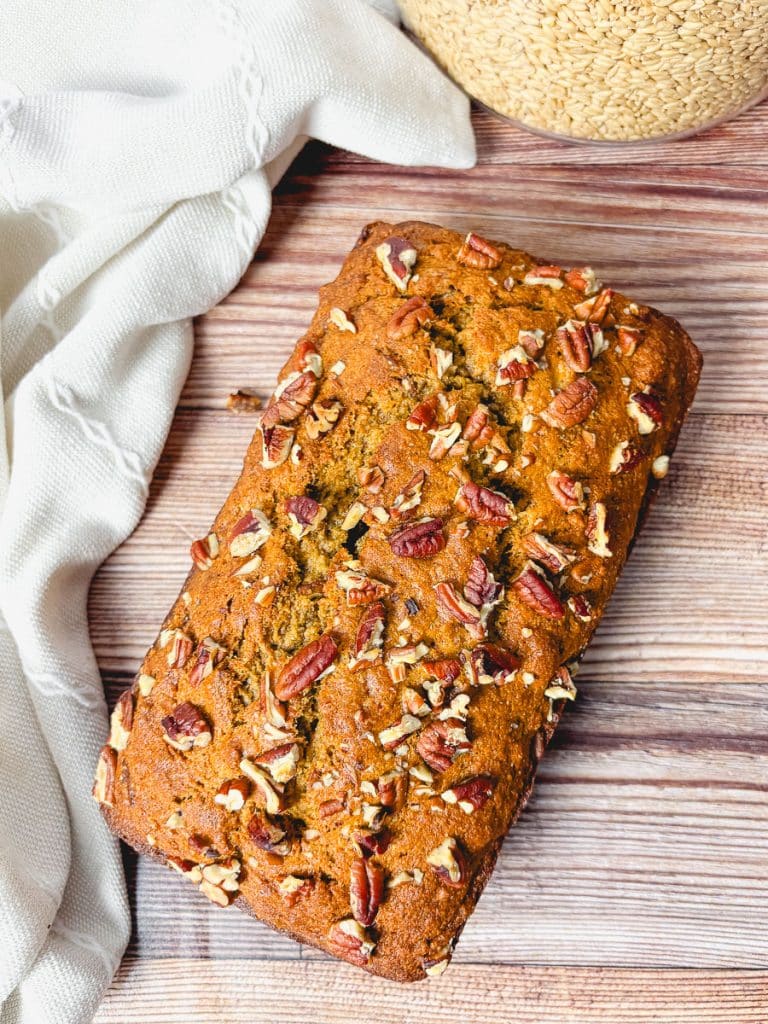 Overhead shot of a pecan-topped banana bread loaf