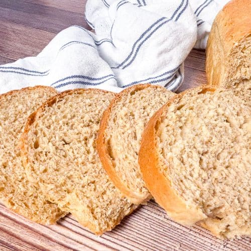 slices of honey wheat sandwich bread on a tea towel