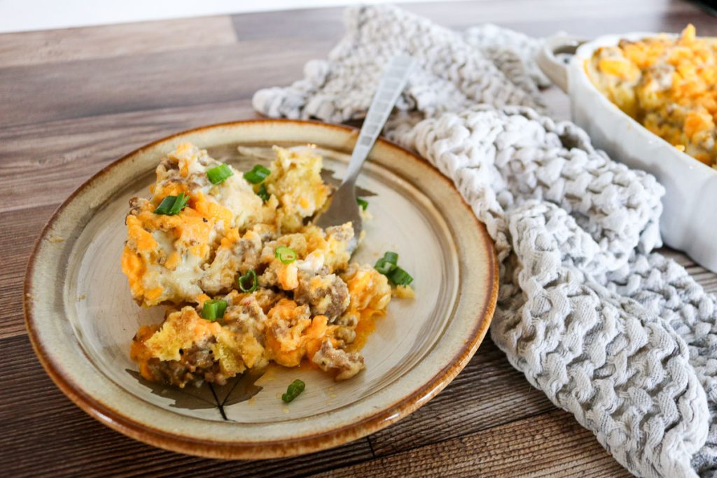 Sourdough breakfast casserole with plated serving beside dish