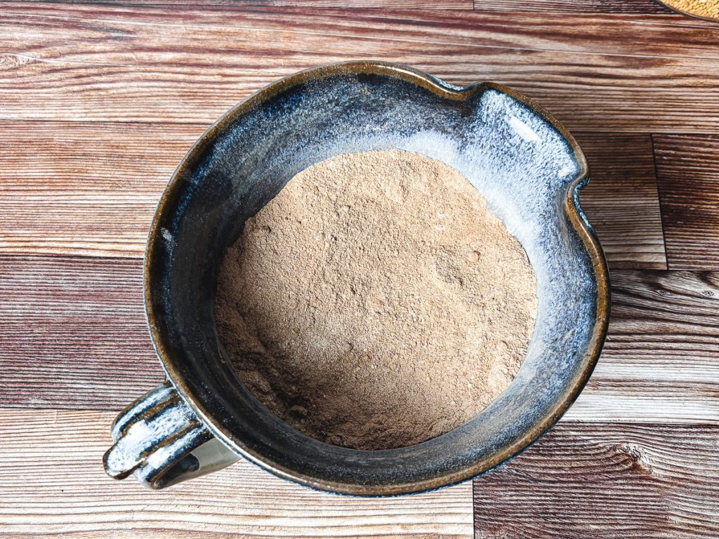 dry chocolate muffin ingredients in a blue pottery bowl