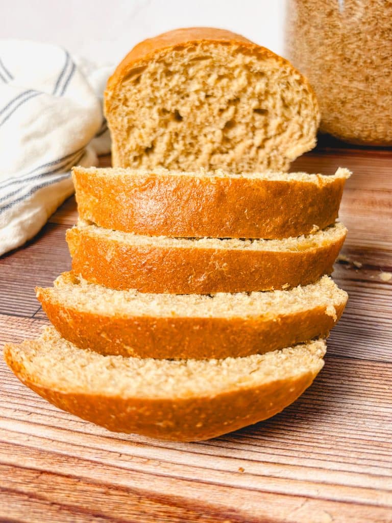 Close-up of sliced honey wheat bread highlighting the soft crumb and golden crust.